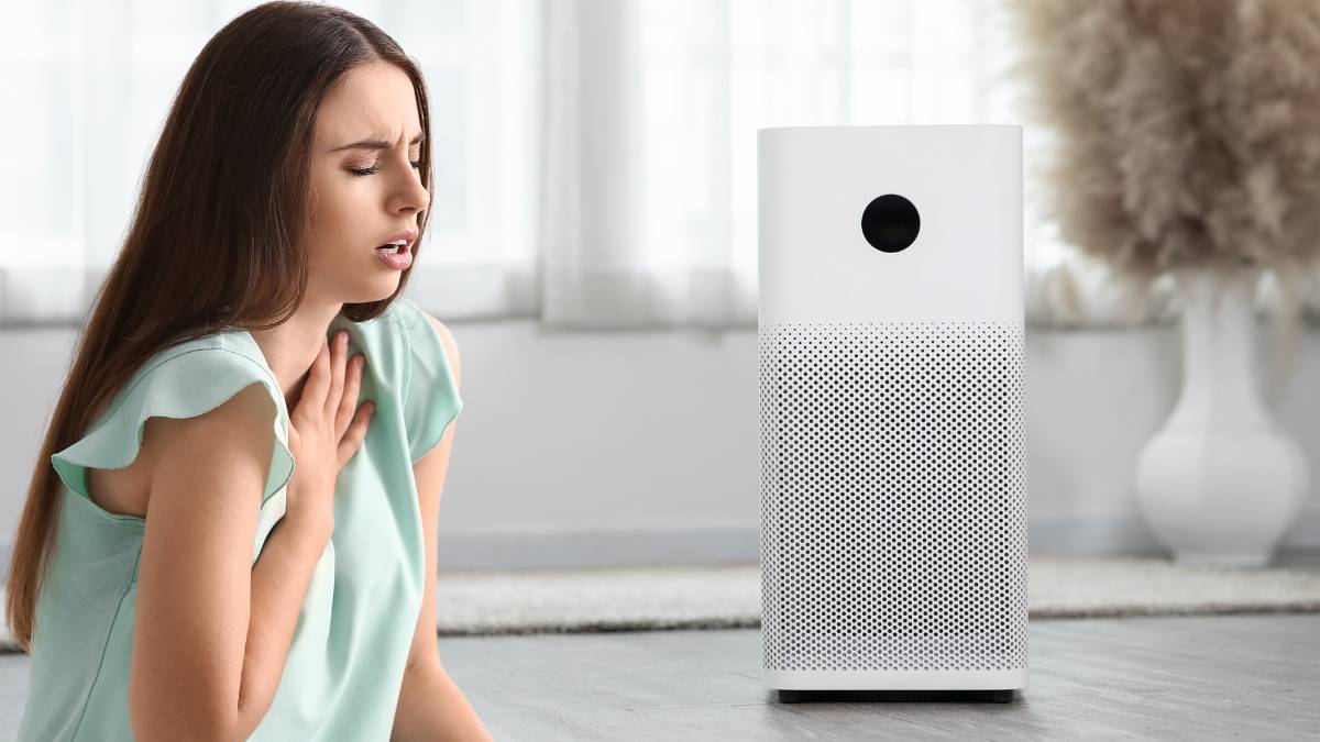 Air purifier in front of girl with trouble breathing