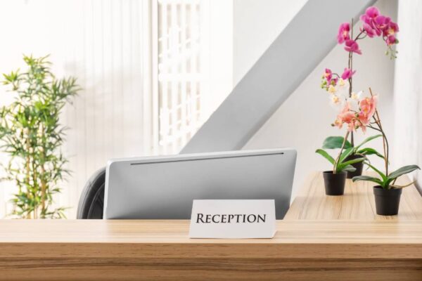 reception desk with flowers on pot