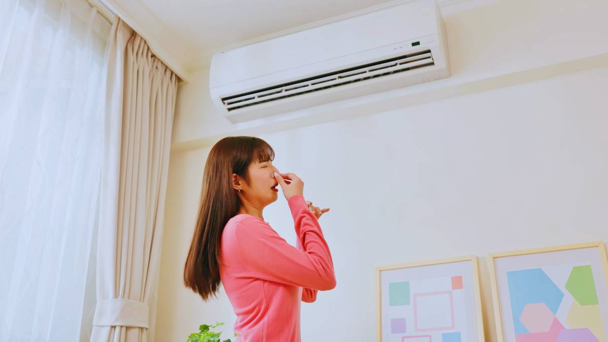 Girl covering her nose due to bad ac smell