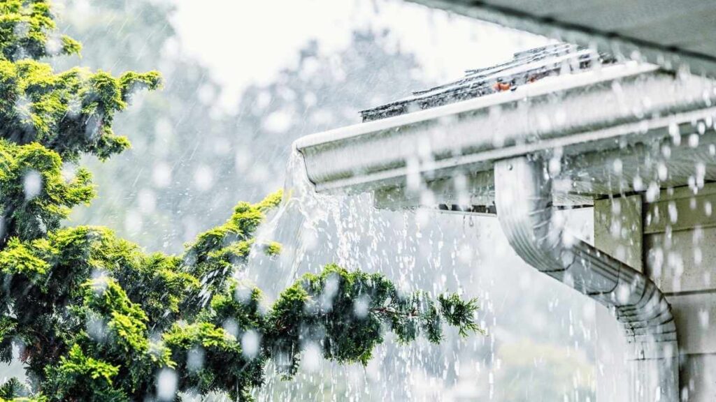 water pouring out of the gutter due to heavy rain