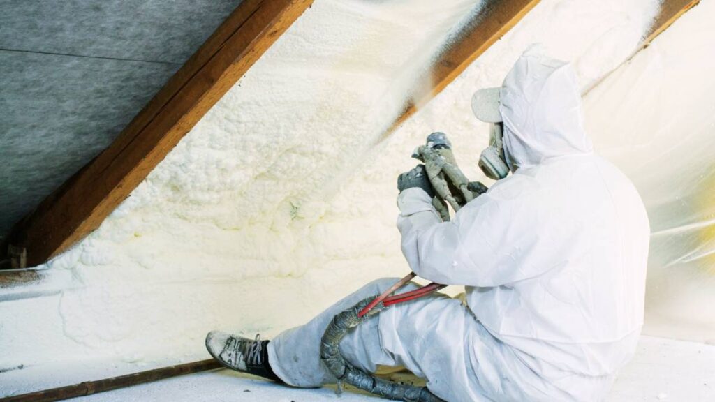 worker doing spray insulation