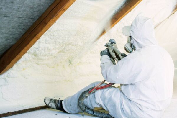 worker doing spray insulation