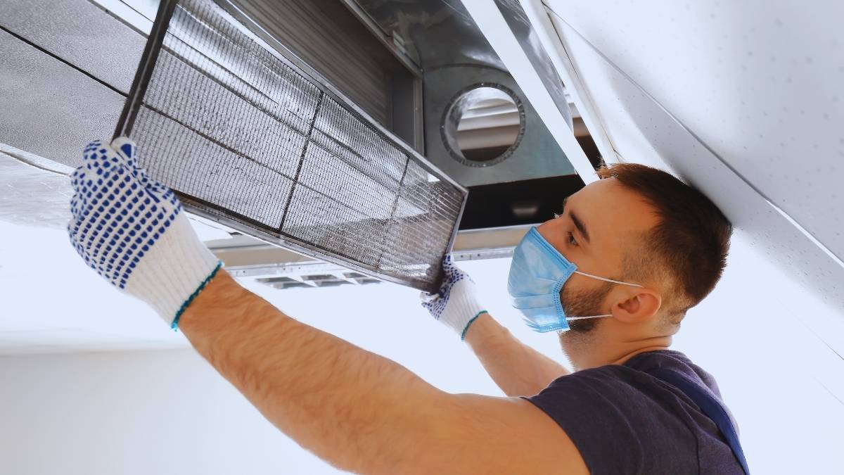 man cleaning an air duct