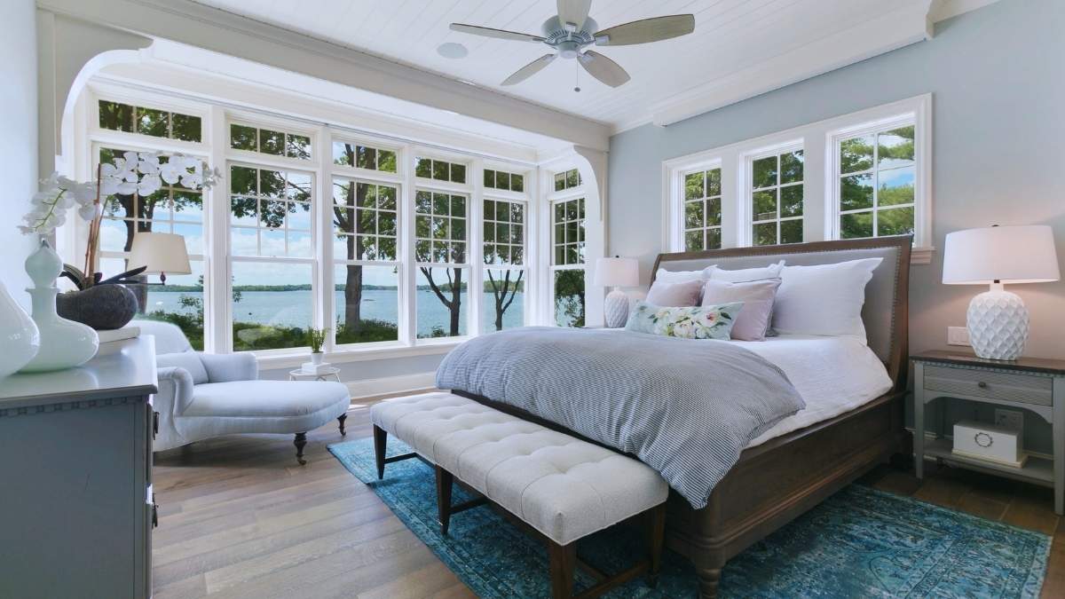 bright bedroom with ceiling fan